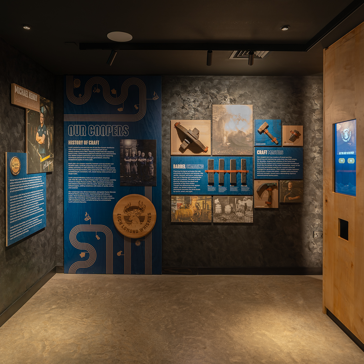 Museum exhibit with informational panels and historical artifacts on a dark wall.